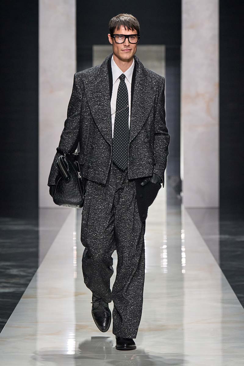 Herenpak van grove tweed van Dolce & Gabbana voor herfst winter 2026 2027, met brede revers, wit overhemd en das met stippen. Photo courtesy of Dolce & Gabbana